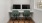  Two computer monitors are sitting on a desk with green chairs.