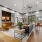  A modern room with a sofa, chairs, and a table with a green plant.