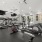 A gym with a variety of exercise equipment including treadmills, stationary bikes, and weight machines.