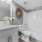  A white bathroom with a toilet, sink, and mirror.