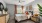  A bedroom with a bed, nightstand, and a ceiling fan.