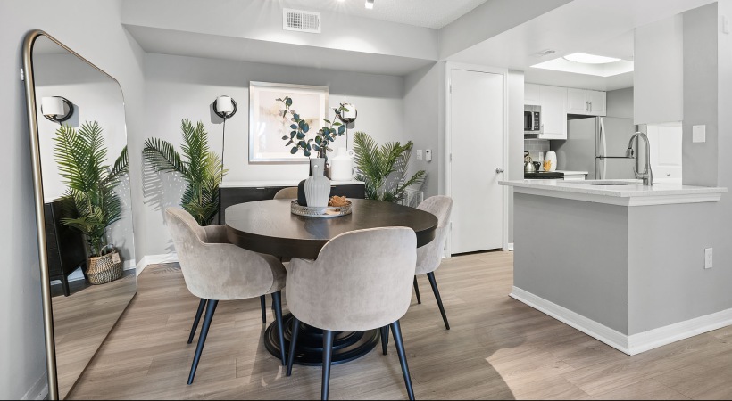  A dining room with a round table and chairs.