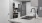  A modern kitchen with a stainless steel refrigerator and a white countertop.
