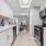  A kitchen with white cabinets and a black stove top oven.