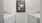  A white washer & dryer and a mirror on the wall.