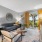  A living room with a grey couch, a coffee table, and a flat screen TV.